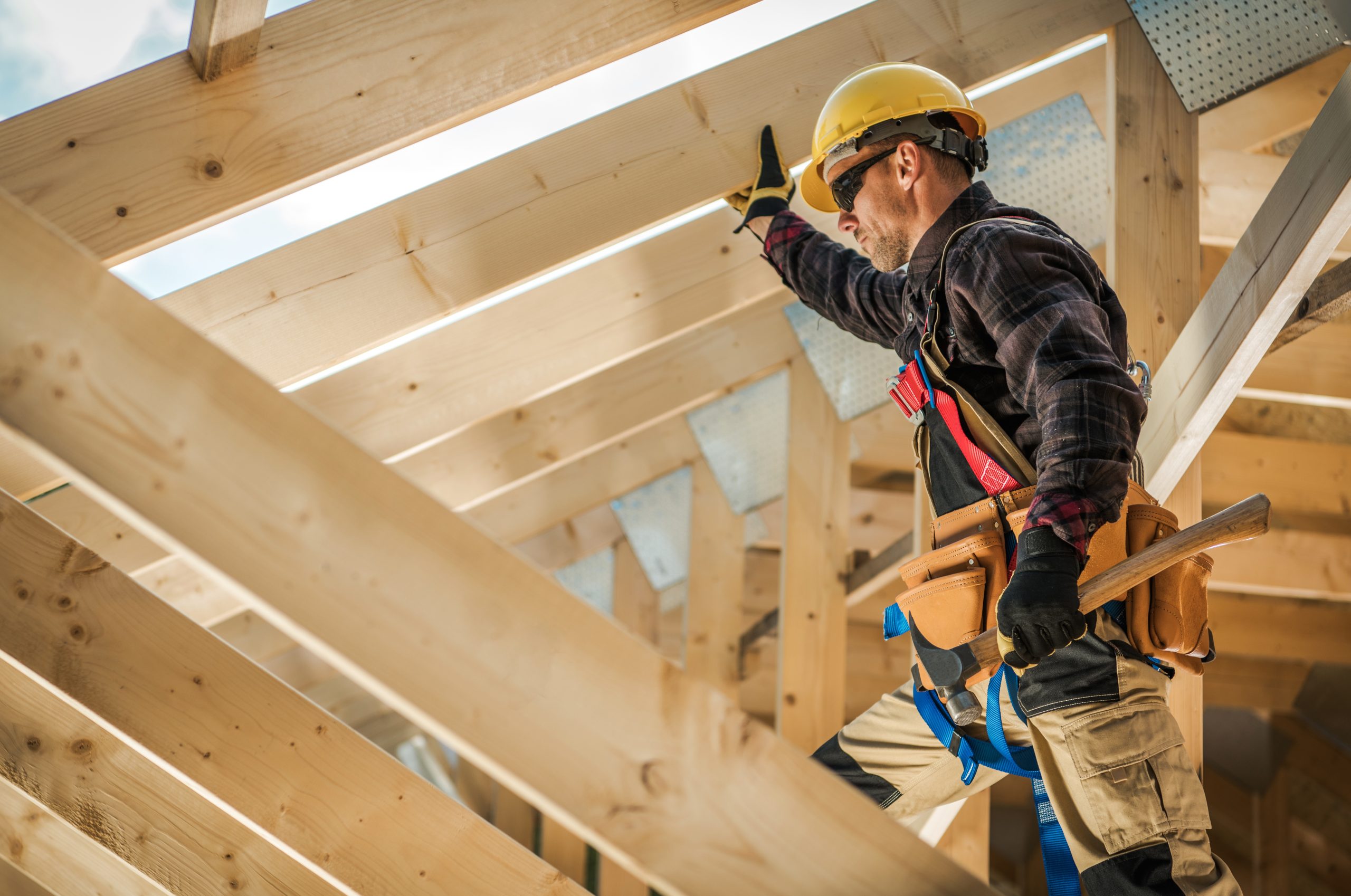 MWK_ourpross_construction3 construction worker standing by wooden framing